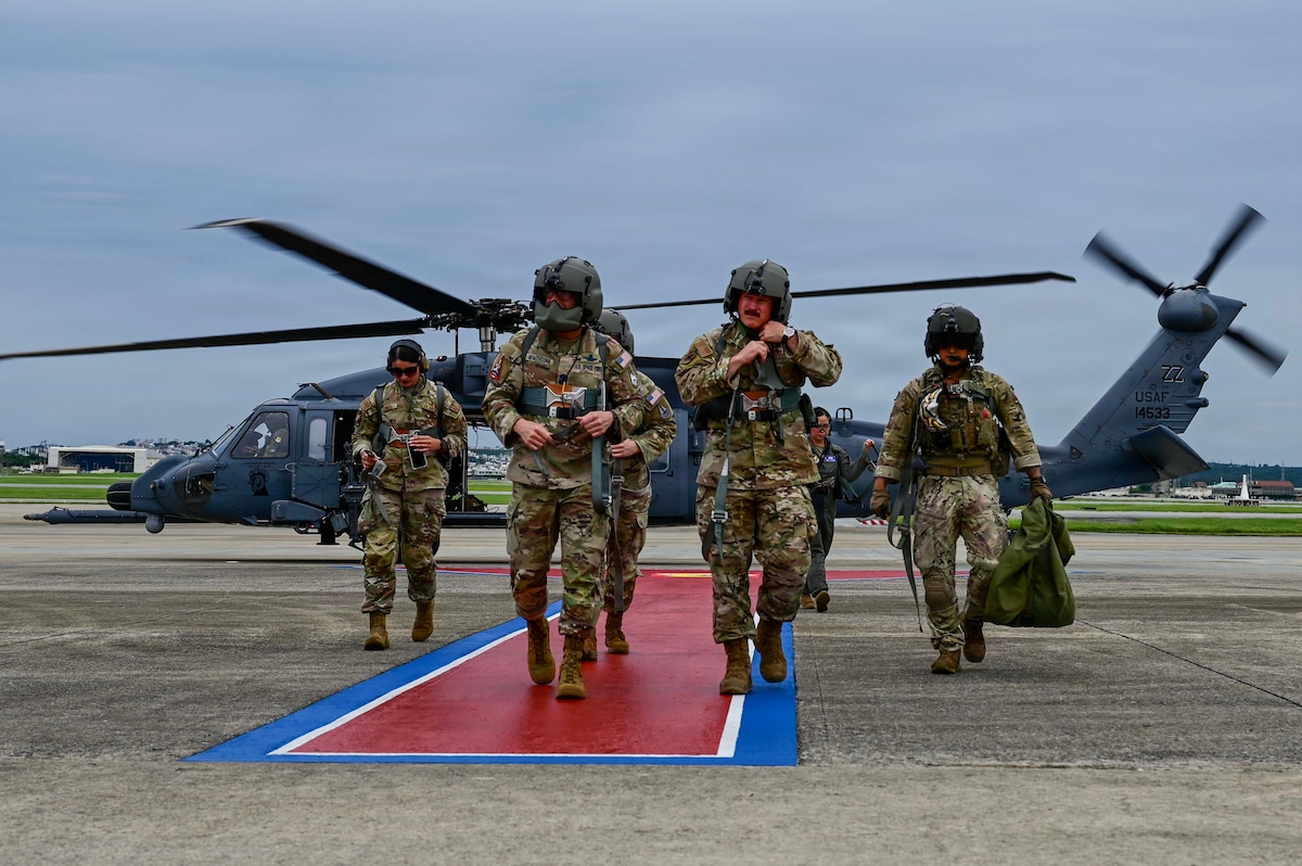 Chief Master Sgt. of the Space Force John Bentivegna and U.S. Air Force Chief Master Sgt. Will Cupp, 18th Wing command chief, disembark an HH-60W Jolly Green II assigned to the 33rd Rescue Squadron at Kadena Air Base, Japan, June 12, 2026. The flight was part of a tour highlighting the joint force and installations across Okinawa. (U.S. Air Force photo by Airman 1st Class Gracelyn Hess)