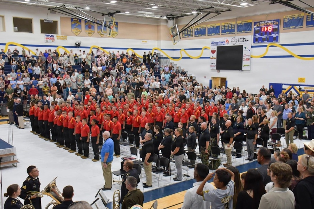 Graduates in a gym during the commencement ceremony