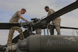Chief Warrant Officer 2 Stephen Schmelzer (left) and Spc. Ishmael Wilson (right), assigned to Bravo Company, 2nd Battalion, 147th Assault Helicopter Battalion, conduct a pre-flight inspection of a UH-60 Black Hawk helicopter in support of air movement operations and Defense Security Cooperation Agency mission requirements at Muscatatuck Urban Training Center in Butlerville, Indiana, June 1, 2026. Bravo Company's mission includes providing aviation support to citizens of the Commonwealth during natural disasters and other emergency situations. (U.S. Army National Guard photo by Spc. Marissa Keith)