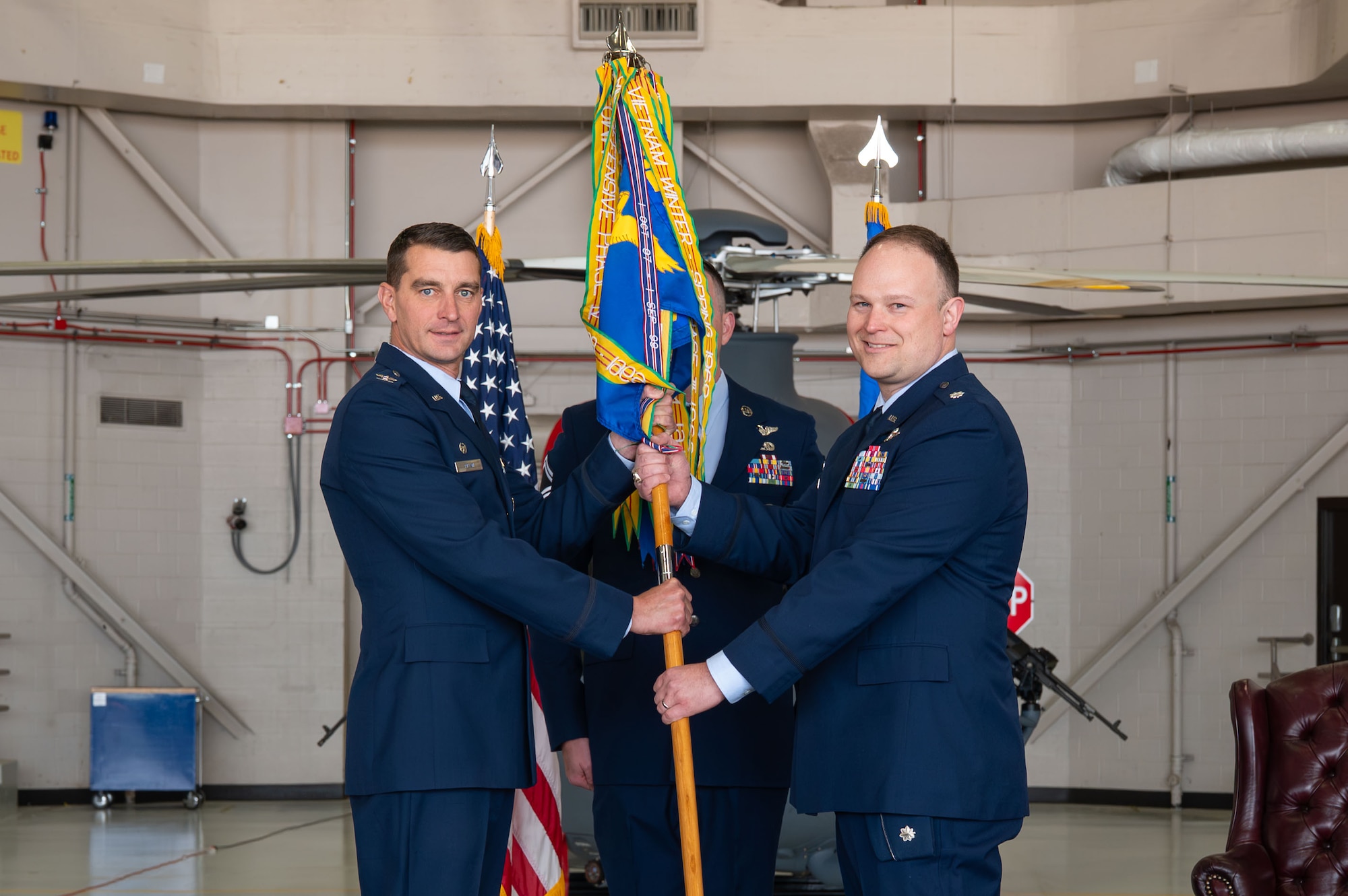 U.S. Air Force Lt. Col. Robert Arcand, right, accepts command of the 40th Helicopter Squadron from Col. Bryant Bevan, 582nd Helicopter Group commander, during a change of command ceremony at Malmstrom Air Force Base, Montana, June 11, 2026.