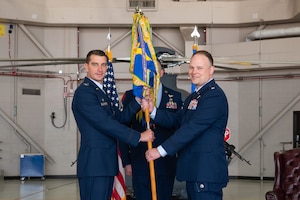 U.S. Air Force Lt. Col. Robert Arcand, right, accepts command of the 40th Helicopter Squadron from Col. Bryant Bevan, 582nd Helicopter Group commander, during a change of command ceremony at Malmstrom Air Force Base, Montana, June 11, 2026.
