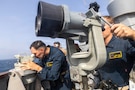 U.S. Sailors monitor a vessel of interest aboard Arleigh Burke-class guided-missile destroyer USS Higgins (DDG 76) June 12, 2026. Higgins is deployed to the U.S. 5th Fleet area of operations to support maritime security and stability in the Middle East. (U.S. Navy photo)