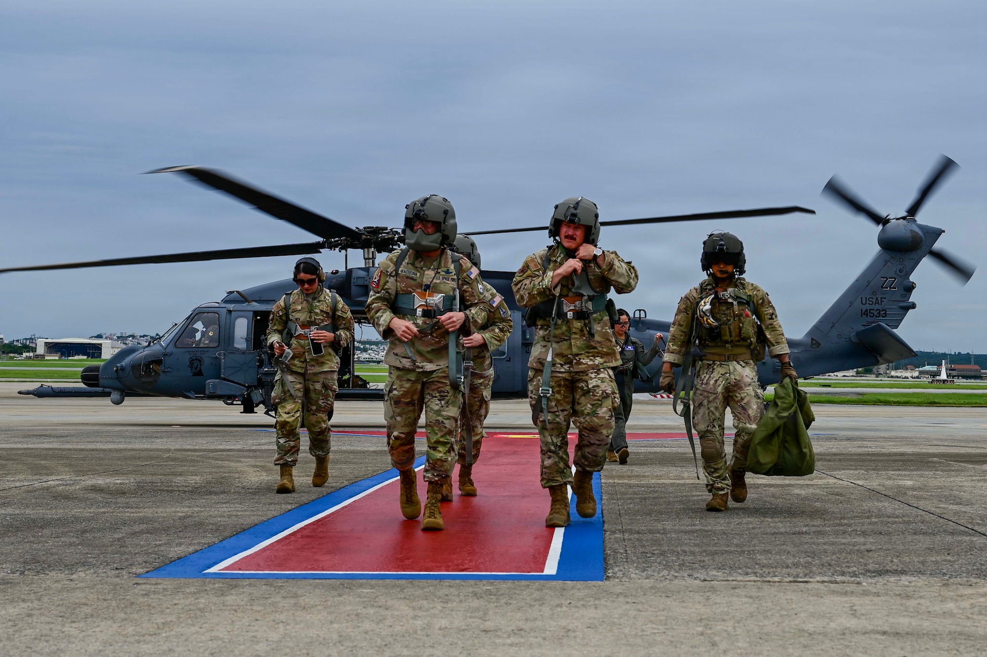 Chief Master Sgt. of the Space Force John Bentivegna and U.S. Air Force Chief Master Sgt. Will Cupp, 18th Wing command chief, disembark an HH-60W Jolly Green II assigned to the 33rd Rescue Squadron at Kadena Air Base, Japan, June 12, 2026. The flight was part of a tour highlighting the joint force and installations across Okinawa. (U.S. Air Force photo by Airman 1st Class Gracelyn Hess)