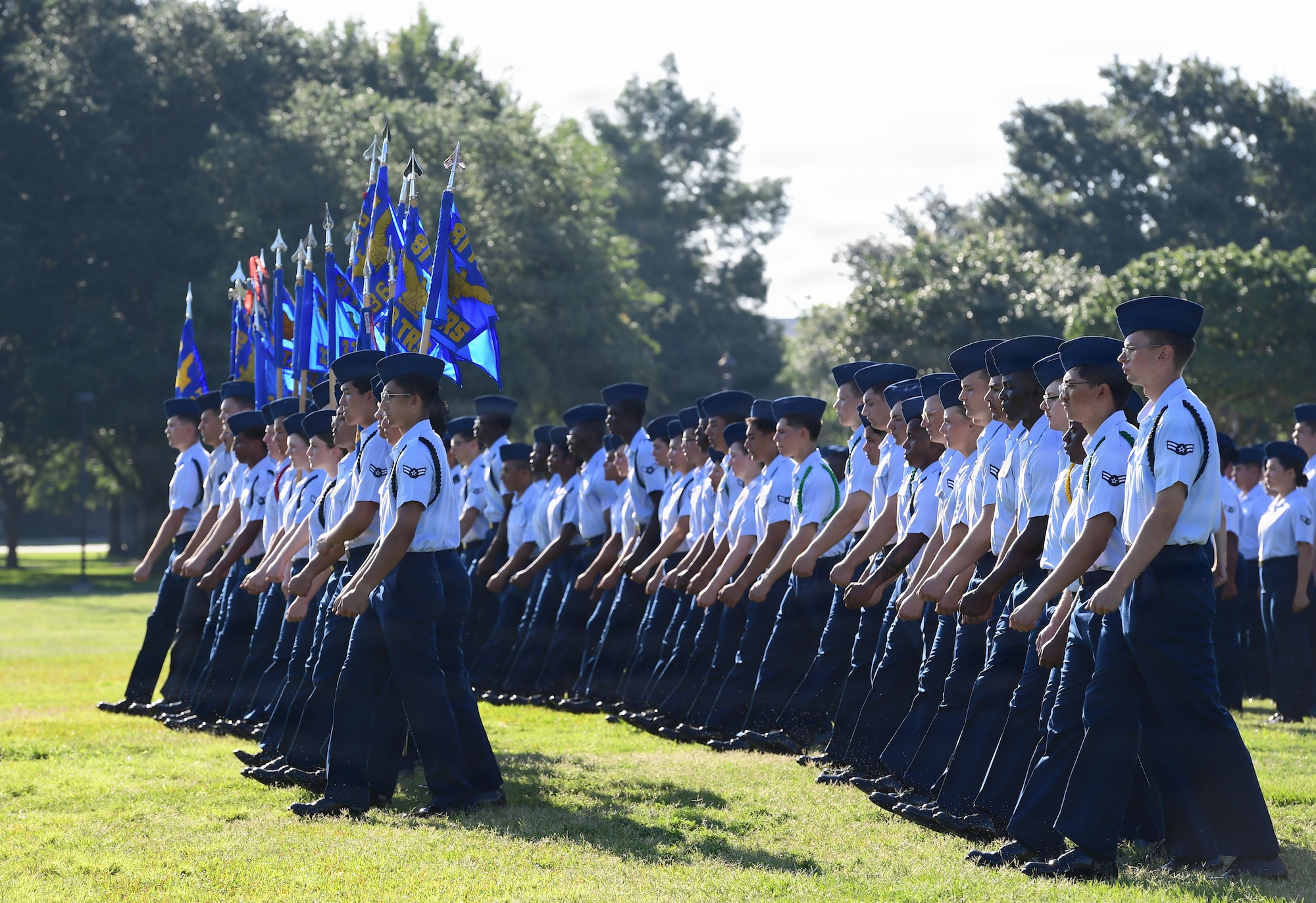 A large group of U.S. Airmen march in formation.