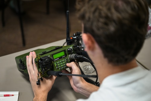 Person holding radio.