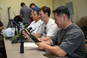 People testing handheld radios.