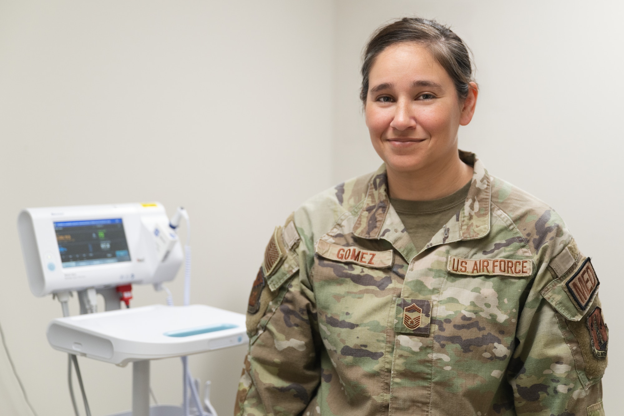 U.S. Air Force Senior Master Sgt. Rachelle Gomez poses for a photo while checking patient vitals