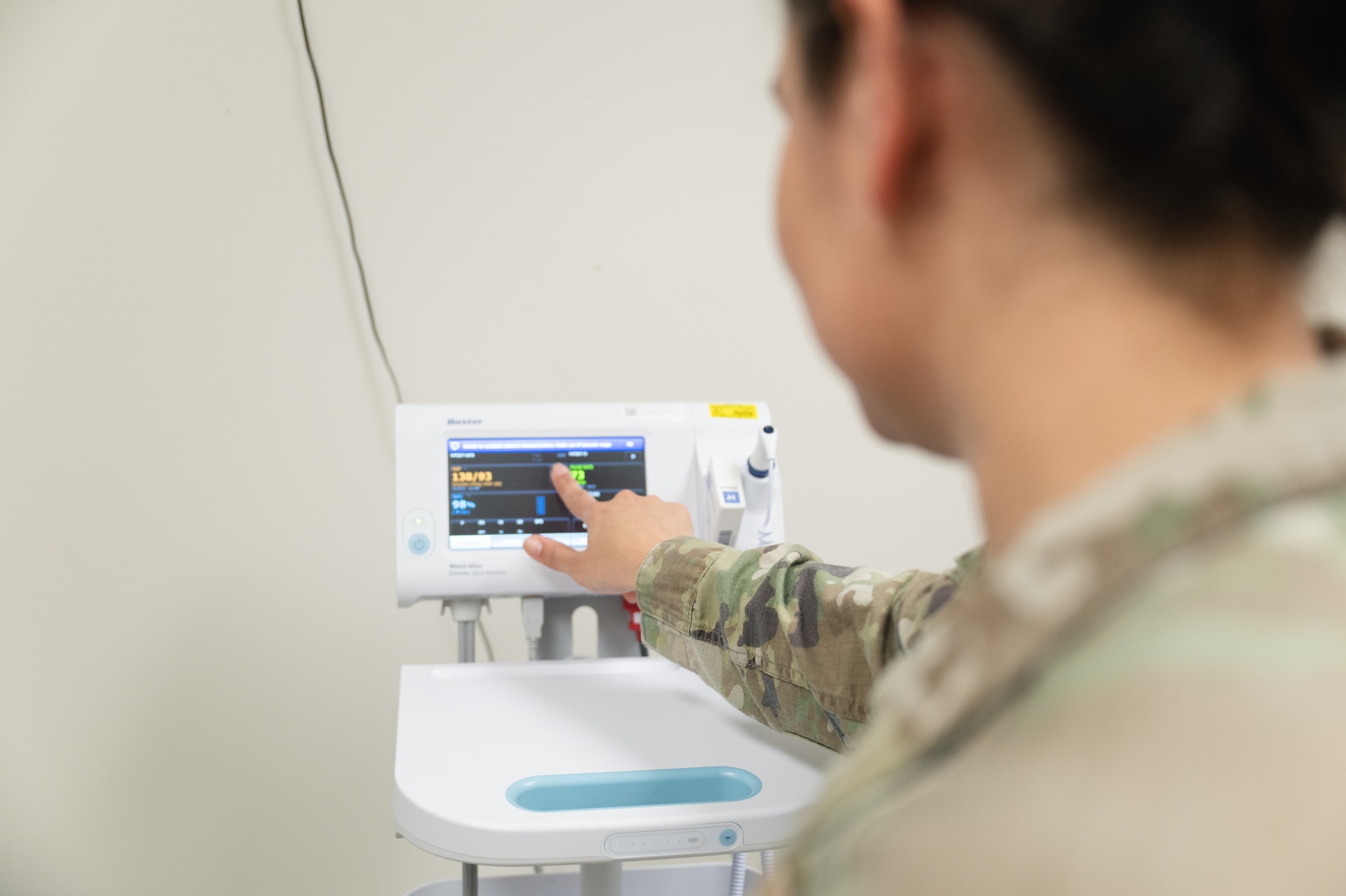 U.S. Air Force Senior Master Sgt. Rachelle Gomez poses for a photo while checking patient vitals