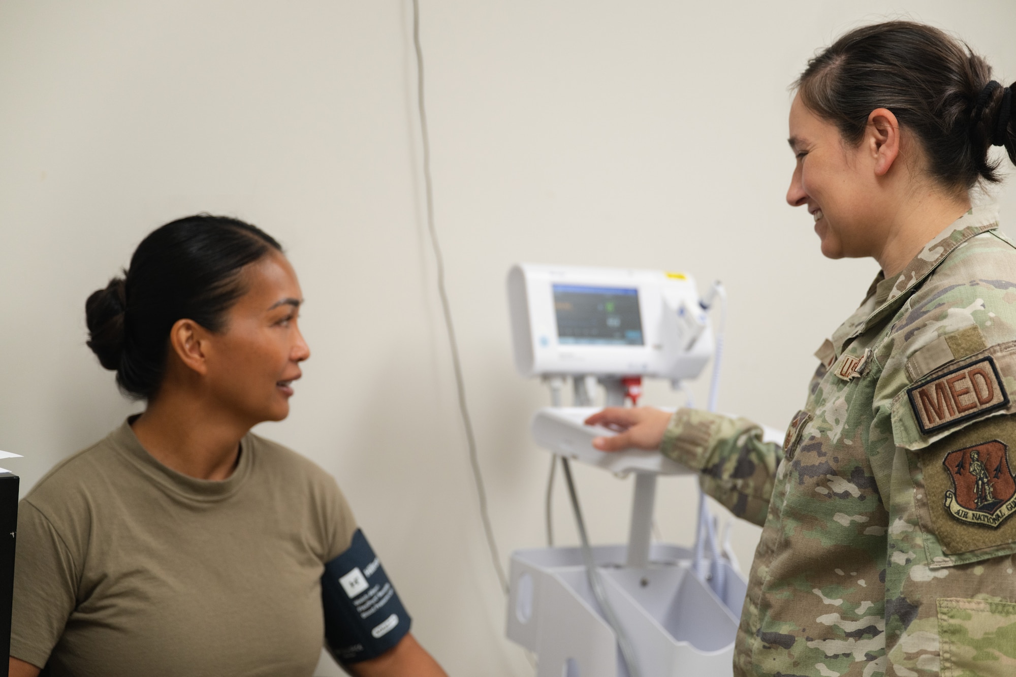 U.S. Air Force Senior Master Sgt. Rachelle Gomez poses for a photo while checking patient vitals