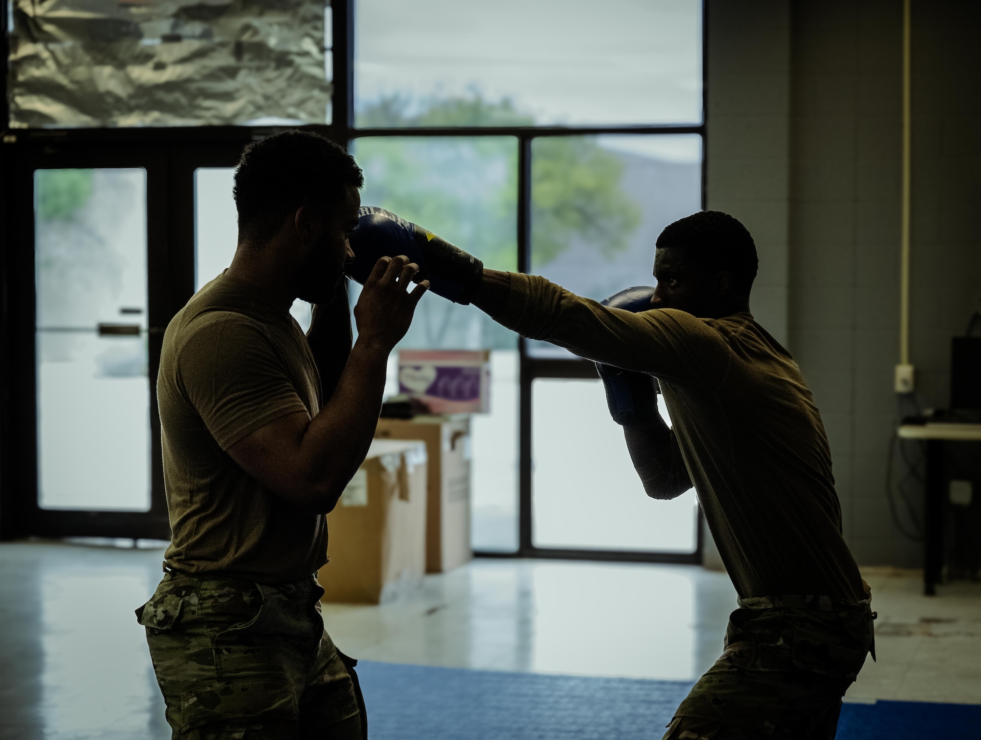 U.S. Air Force Senior Airman Daevon Larkins, 47th Security Forces Squadron trainer, (right) spars with U.S. Air Force Senior Airman Raeshon Correa, 47th Security Forces Squadron defender, (left) to prepare for the Phoenix Raven course at Laughlin Air Force Base, Texas, April 16, 2026. Larkins went through pre-Raven course training before attending the 28-day Phoenix Raven Qualification Course at Joint Base McGuire-Dix-Lakehurst, New Jersey. (U.S. Air Force photo by Airman 1st Class Harrison Sullivan)