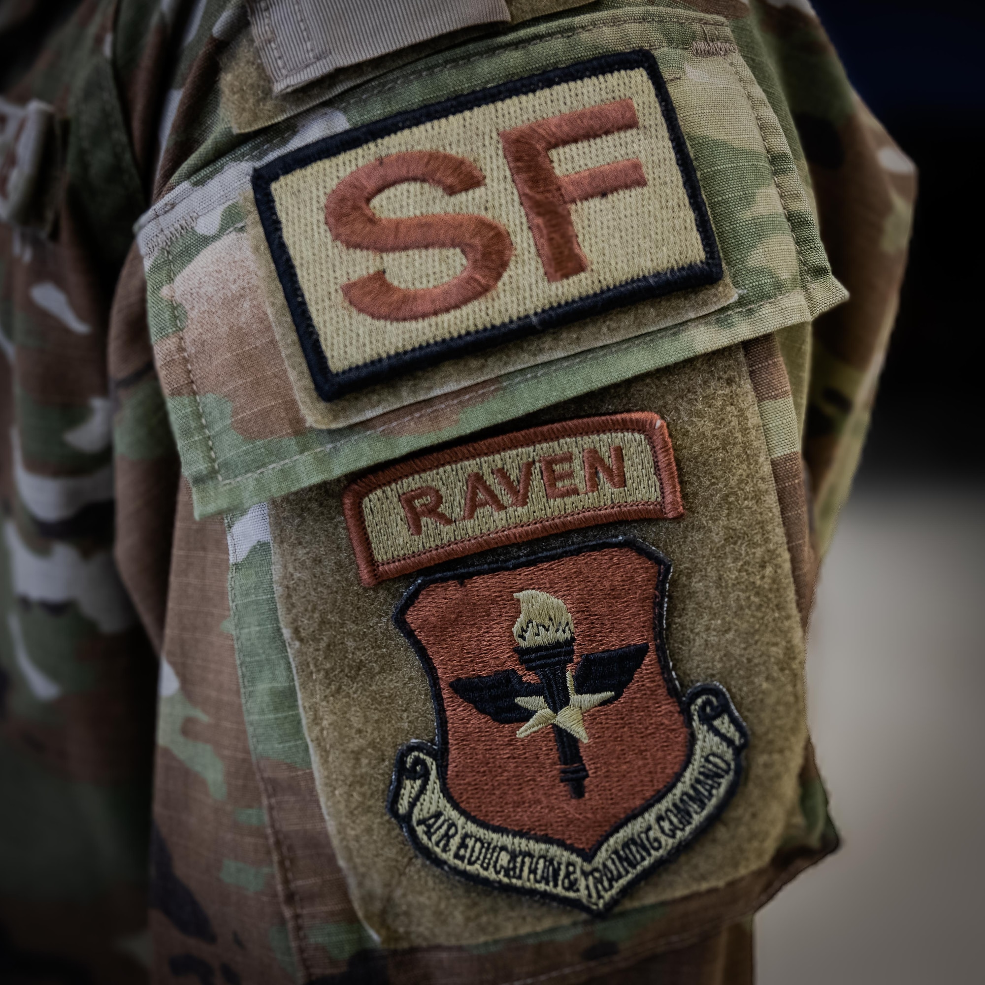 A Phoenix Raven tab is displayed on the uniform of Airman 1st Class Larkins, 47th Security Forces Squadron trainer, at Laughlin Air Force Base, Texas, June 15, 2026. The Phoenix Raven Qualification Course prepares future Ravens to ensure the security of aircrew, aircraft and cargo in hostile or high-threat areas.