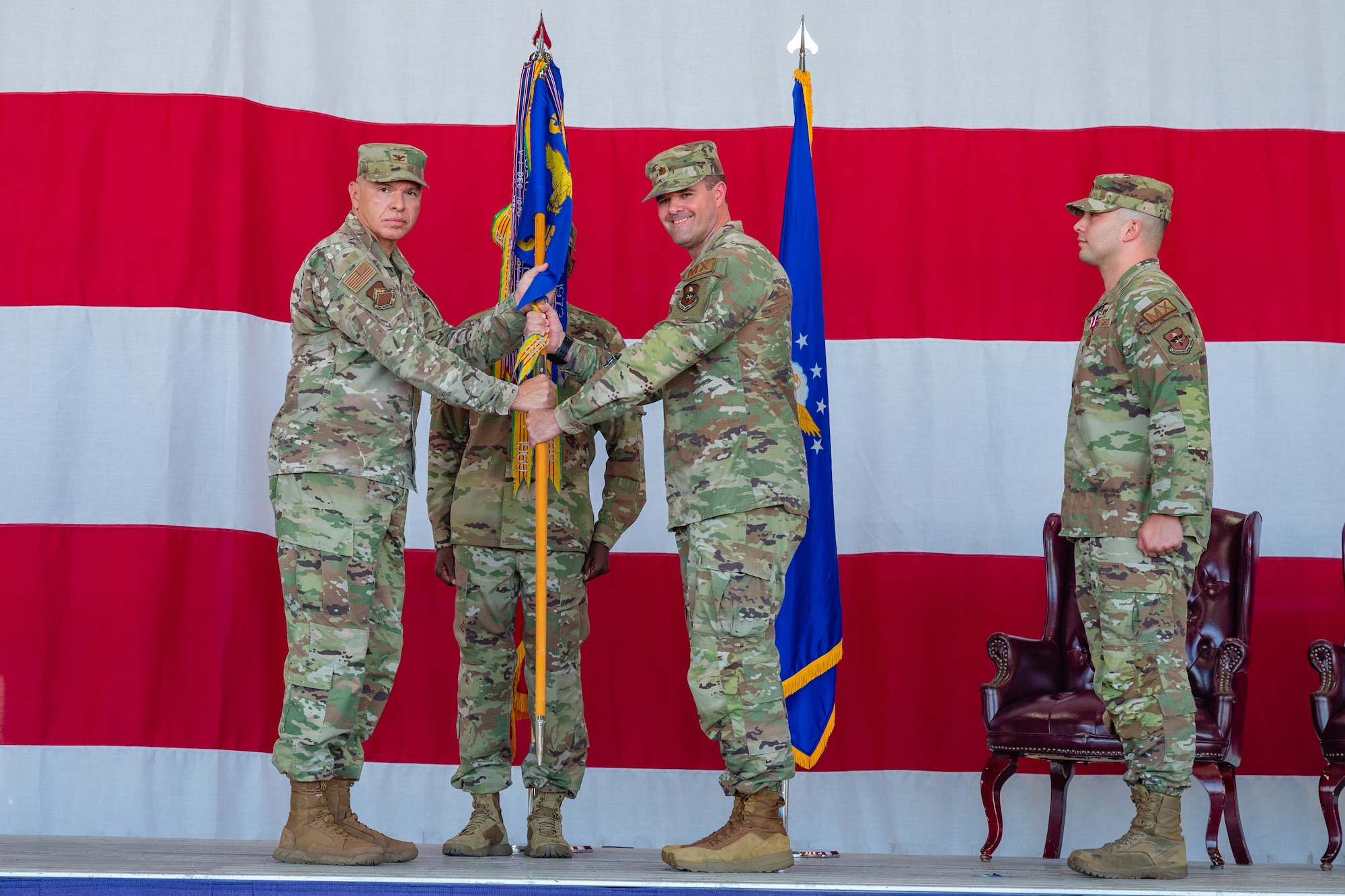U.S. Air Force Col. Edward Romero, 56th Maintenance Group commander, passes the guidon to Maj. Randy Garner, incoming 56th Component Maintenance Squadron commander, at Luke Air Force Base, Arizona, June 15, 2026.