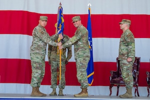 U.S. Air Force Col. Edward Romero, 56th Maintenance Group commander, passes the guidon to Maj. Randy Garner, incoming 56th Component Maintenance Squadron commander, at Luke Air Force Base, Arizona, June 15, 2026.