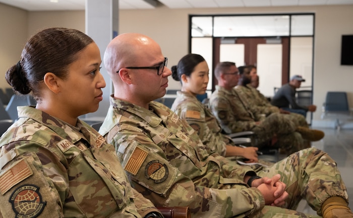 Air Transportation Specialist are briefed by senior enlisted leadership.