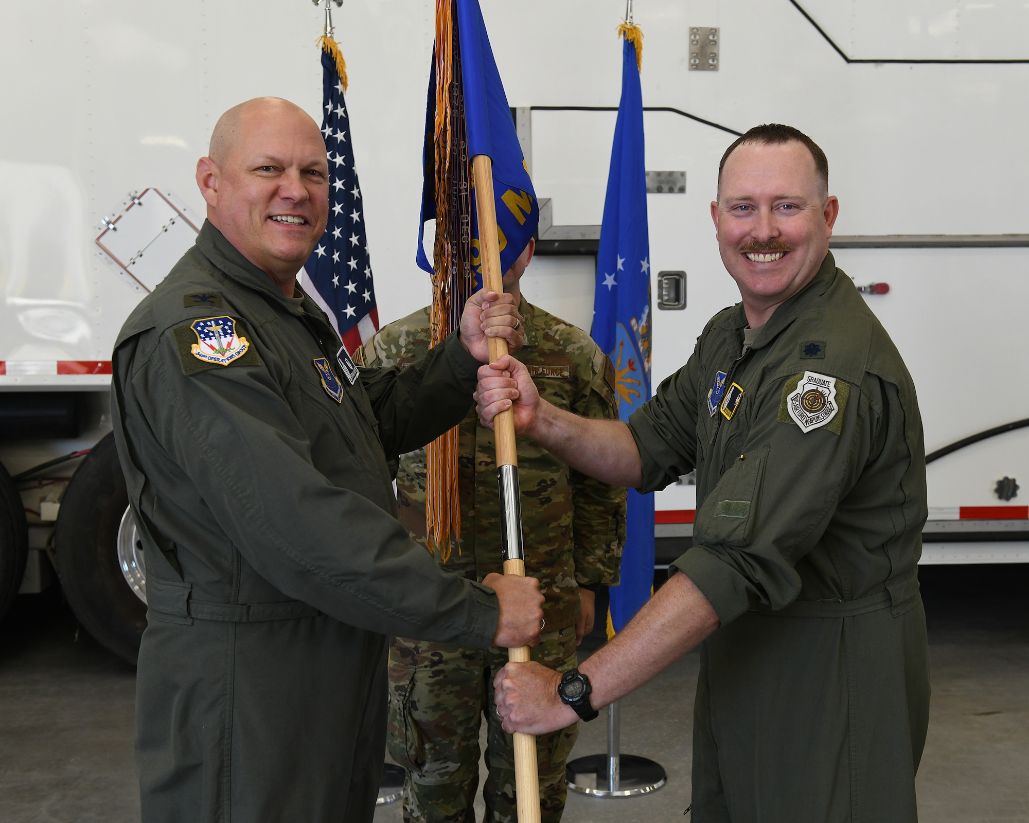 U.S. Air Force Lt. Col. Lee Payne, right, accepts command of the 490th Missile Squadron from Col. Stephen Meister, 341st Operations Group commander, during a change of command ceremony at Malmstrom Air Force Base, Montana, June 12, 2026.
