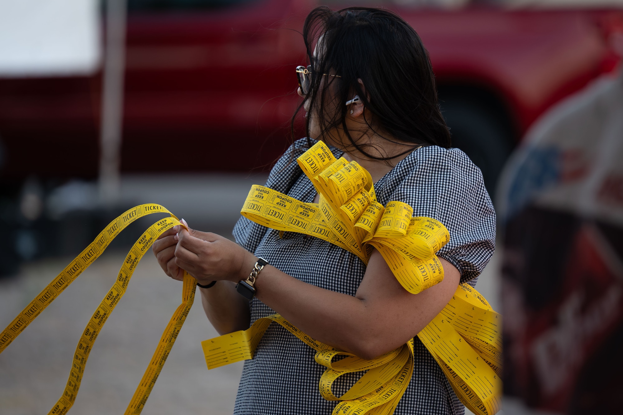 An event attendee holds a stack of raffle tickets during Freedom Fest at Davis-Monthan Air Force Base, Arizona, June 12, 2026. Freedom Fest provided Airmen, families and civilian personnel an opportunity to strengthen community ties and build connections through shared experiences and recreational activities. (U.S. Air Force photo by Airman 1st Class Jaden Kidd)