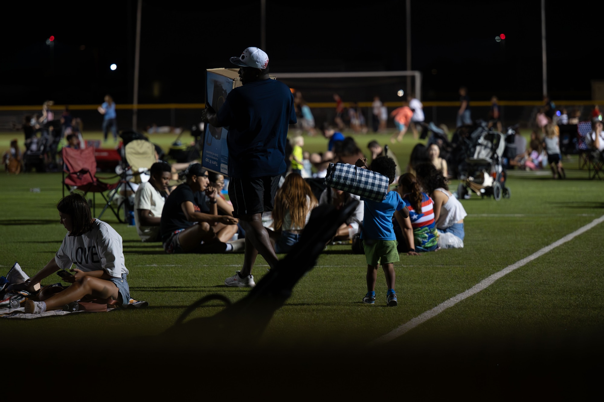 Attendees gather before a fireworks display during Freedom Fest at Davis-Monthan Air Force Base, Arizona, June 12, 2026. The event brought together Airmen, families and community members to celebrate shared traditions and reinforce the sense of belonging that supports the Air Force mission. (U.S. Air Force photo by Airman 1st Class Jaden Kidd)