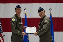 Brig. Gen. Lawrence Sullivan, outgoing 57th Wing commander, is presented the Legion of Merit award by Maj. Gen. David Epperson, left, U.S. Air Force Warfare Center commander, during a change of command ceremony at Nellis Air Force Base, Nevada, June 15, 2026.