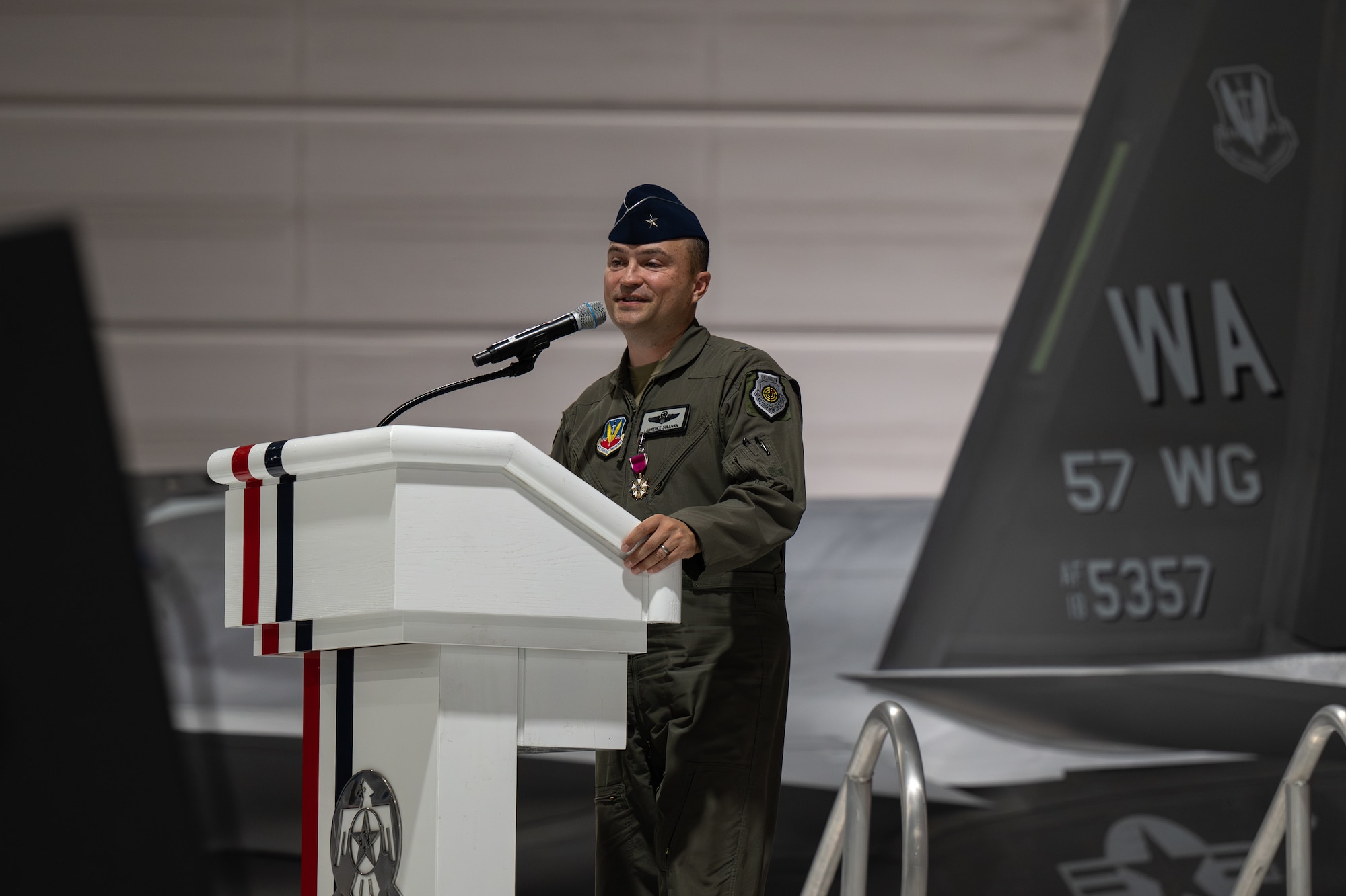 Brig. Gen. Lawrence Sullivan stands behind a podium giving his remarks.