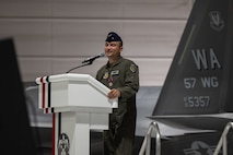 Brig. Gen. Lawrence Sullivan stands behind a podium giving his remarks.