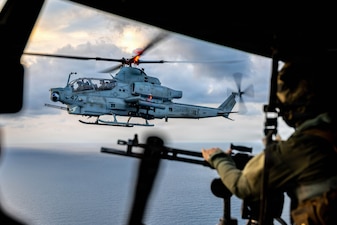 A U.S. Marine Corps AH-1Z Viper assigned to Marine Medium Tiltrotor Squadron (VMM) 163 (Reinforced), 11th Marine Expeditionary Unit, conducts a fly-by during aerial sniper training in the South China Sea, June 12, 2026.