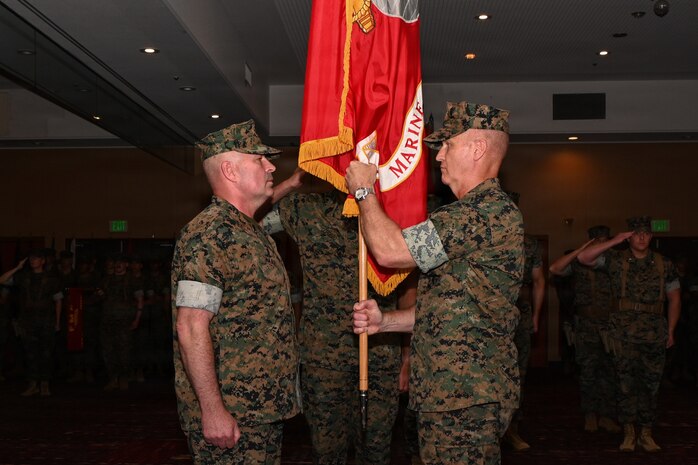 U.S. Marine Corps Brig. Gen. Kevin Collins, right, outgoing commanding general of 3rd Marine Logistics Group, prepares to relinquish command of 3rd MLG to Brig. Gen. Christopher Haar, incoming commanding general of 3rd MLG, during a change of command ceremony on Camp Kinser, Okinawa, Japan, June 3, 2026. The ceremony marked the formal transfer of authority and responsibility, honoring Collins’ leadership and service while welcoming Haar as the incoming commanding general. Marines, Sailors, family members, and distinguished guests gathered to recognize the enduring legacy of leadership within 3rd MLG and reaffirm the unit’s commitment to supporting III Marine Expeditionary Force throughout the Indo-Pacific. (U.S. Marine Corps photo by Lance Cpl. Rachel Mason)