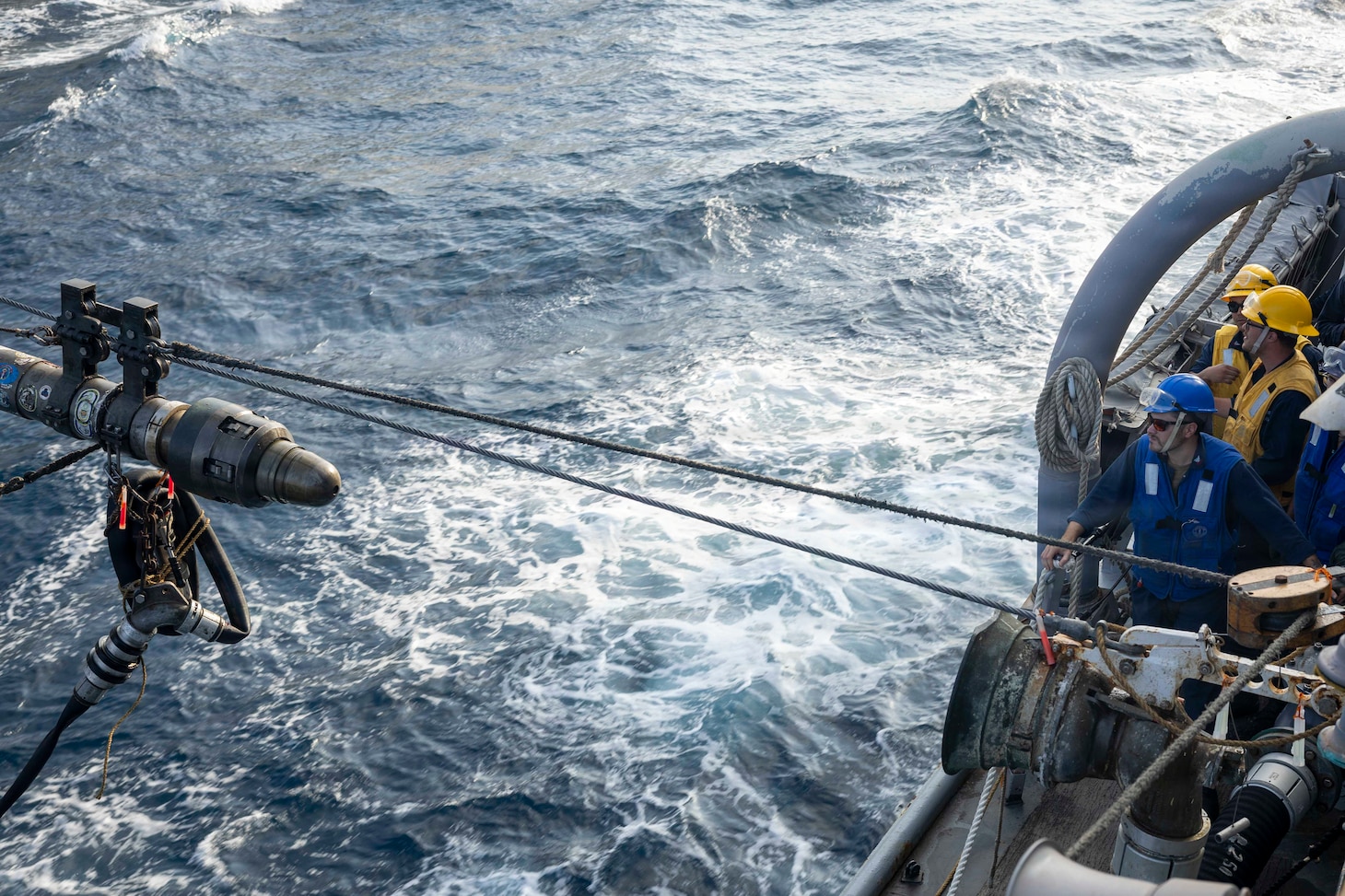 U.S. Sailors, assigned to Arleigh Burke-class guided-missile destroyer USS Delbert D. Black (DDG 119), observe an incoming fuel probe during a replenishment-at-sea with fleet replenishment oiler USNS Henry J. Kaiser (T- AO 187), in support of Operation Epic Fury, March 19, 2026. (U.S. Navy photo)