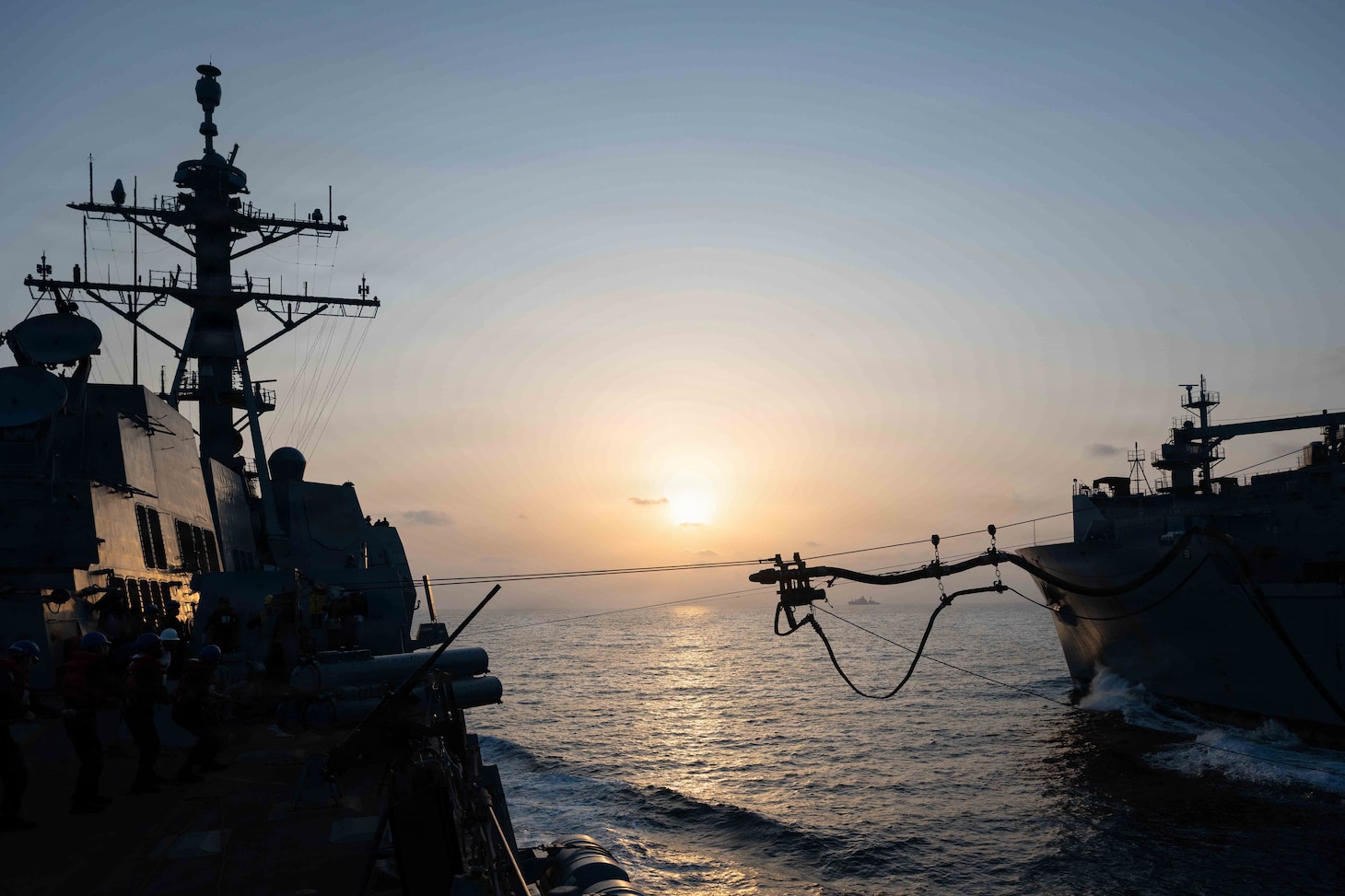 Arleigh Burke-class guided-missile destroyer USS Pinckney (DDG 91) conducts a replenishment-at-sea with Lewis and Clark-class dry cargo and ammunition ship USNS Carl Brashear (T-AKE 7) during Operation Epic Fury, March 19, 2026. (U.S. Navy photo)
