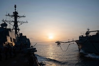 Arleigh Burke-class guided-missile destroyer USS Pinckney (DDG 91) conducts a replenishment-at-sea with Lewis and Clark-class dry cargo and ammunition ship USNS Carl Brashear (T-AKE 7) during Operation Epic Fury, March 19, 2026. (U.S. Navy photo)