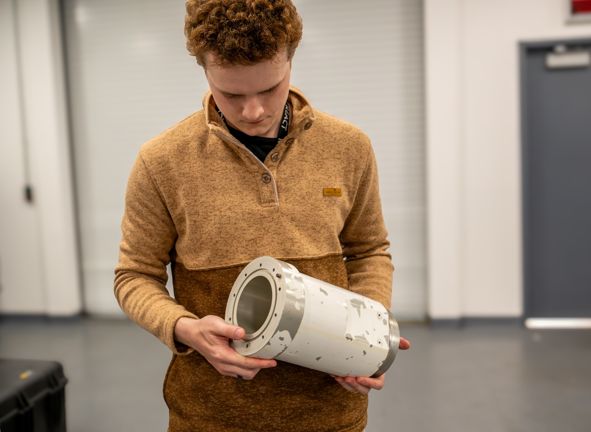 man holds boom to drogue adapter