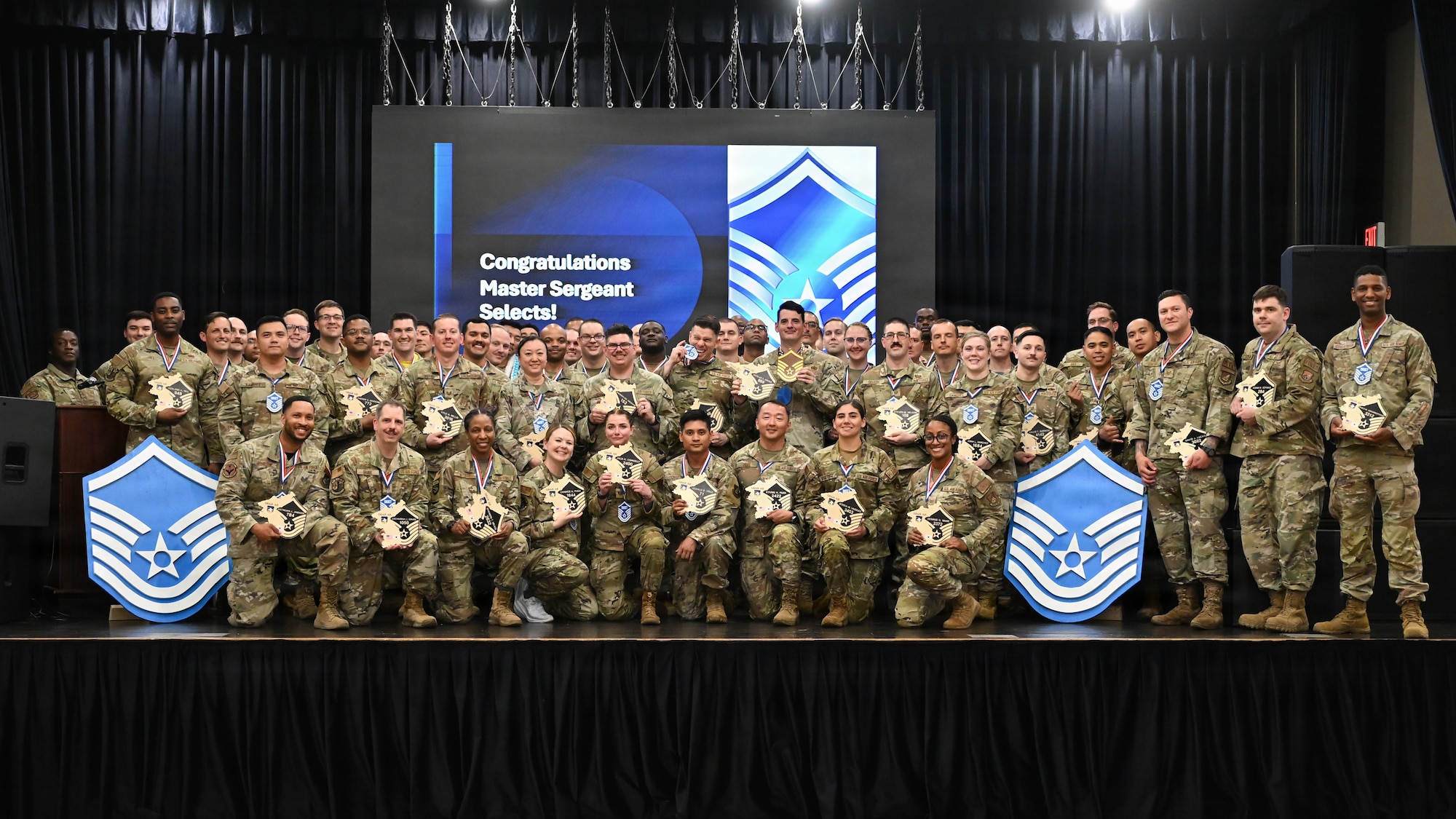 U.S. Air Force master sergeant selects pose for a group photo during a master sergeant release celebration at Osan Air Base, Republic of Korea, June 12, 2026. The event recognized Airmen selected for promotion to master sergeant and celebrated their achievement as they prepared to join the senior noncommissioned officer tier. (U.S. Air Force photo by Senior Airman Megan Cusmano)