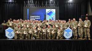 U.S. Air Force master sergeant selects pose for a group photo during a master sergeant release celebration at Osan Air Base, Republic of Korea, June 12, 2026. The event recognized Airmen selected for promotion to master sergeant and celebrated their achievement as they prepared to join the senior noncommissioned officer tier. (U.S. Air Force photo by Senior Airman Megan Cusmano)