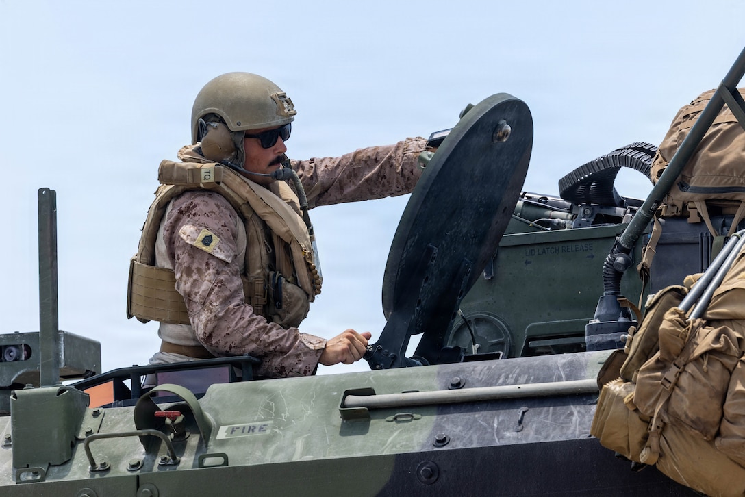 U.S. Marine Corps Gunnery Sgt. Alexander Panetta, a platoon sergeant with 2nd Assault Amphibian Battalion, 2nd Marine Division, closes the hatch to an ACV during a shore-to-ship movement to accomplish training objectives within the Naval Integrated Training Package-2 and Amphibious Mobility Warfare Certifications as a part of 26th Marine Expeditionary Unit's during Type Commander’s Amphibious Training (TCAT) on Marine Corps Base Camp Lejeune, North Carolina, June 14, 2026. TCAT is a military exercise designed to enhance mobility and integration between the U.S. Marine Corps and the U.S. Navy. The amphibious force is an integrated powerhouse providing sea, land, and air operations, giving geographic combatant commanders a more flexible, agile force for aggregated or dis-aggregated operations across the globe.  (U.S. Marine Corps photo by Cpl. Channah Chilton)