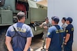 U.S. Army Staff Sgt. John Segawa, center, a station chief assigned to the 297th Engineer Detachment Firefighting Team, 103D Troop Command, Hawaii Army National Guard, explains his equipment and capabilities to the Honolulu Fire Department in Nanakuli, Hawaii, Aug. 1, 2025.