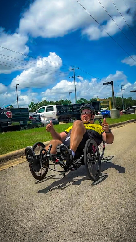Retired Master Sgt. Christopher Morago, a Team Army competitor, gives two thumbs up while riding a recumbent bike during practice ahead of the 2026 Warrior Games in San Antonio, Texas, June 10, 2026.