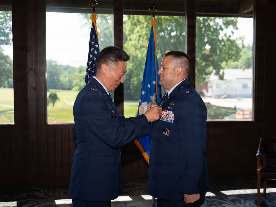 Chain of command presents medal to outgoing commander.