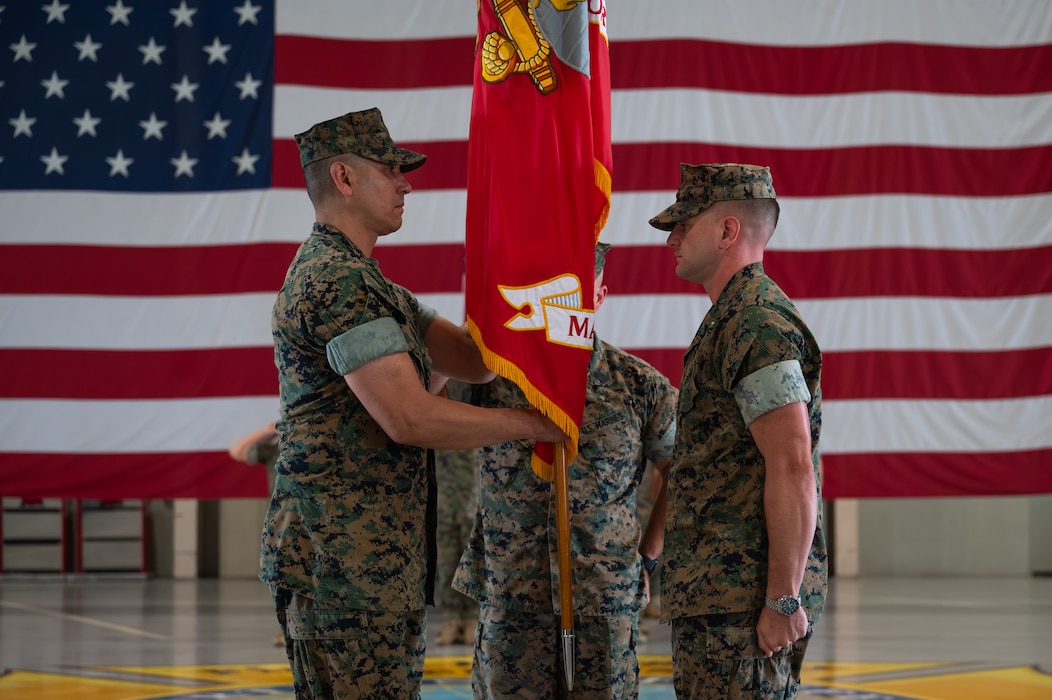 U.S. Marine Corps Lt. Col. David Rubio, incoming Marine Corps Detachment Goodfellow commanding officer, receives the detachment colors from Lt. Col. Brian Meade, outgoing MCD Goodfellow commanding officer, during the change of command ceremony at the Louis F. Garland Department of War Fire Academy, Goodfellow Air Force Base, Texas, June 12, 2026. Meade relinquished his duties as commanding officer of MCD Goodfellow to Rubio after commanding for two years. (U.S. Air Force photo by Senior Airman Brian Lummus)