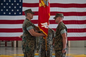U.S. Marine Corps Lt. Col. David Rubio, incoming Marine Corps Detachment Goodfellow commanding officer, receives the detachment colors from Lt. Col. Brian Meade, outgoing MCD Goodfellow commanding officer, during the change of command ceremony at the Louis F. Garland Department of War Fire Academy, Goodfellow Air Force Base, Texas, June 12, 2026. Meade relinquished his duties as commanding officer of MCD Goodfellow to Rubio after commanding for two years. (U.S. Air Force photo by Senior Airman Brian Lummus)