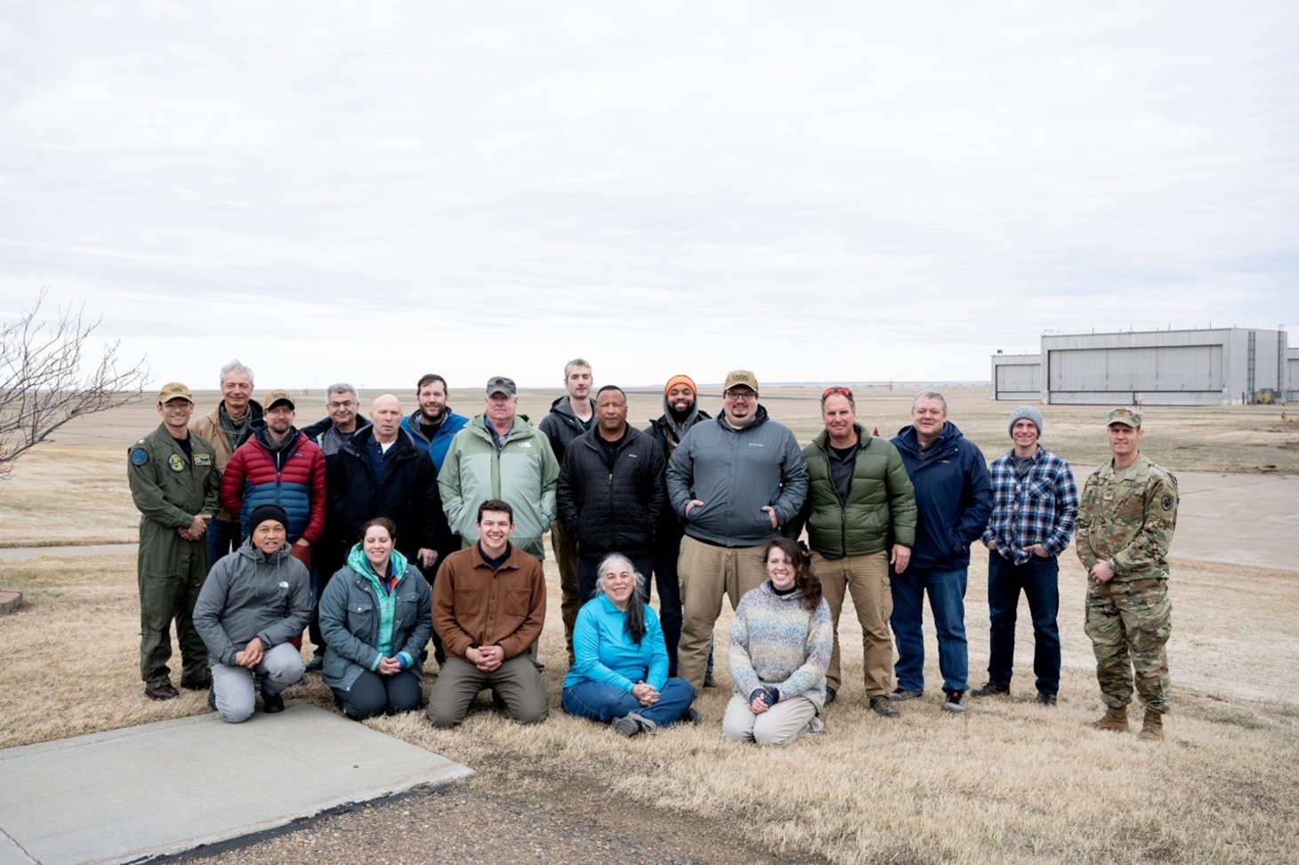 U.S. Naval Research Laboratory (NRL) partners and observers gather for a group photo while testing a dual-use in power beaming and aerial defense systems. NRL continues to work with Boeing and the U.S. Army to test the capability of a dual-use laser system. (U.S. Navy photo by Jonathan Steffen-Arnold)