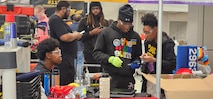 Students from the Anacostia High School Robotics team, the "AnaDroids," participated in a FIRST Robotics Competition in Severn, Maryland, supported by PAE SSP's Ishmael Kamara.