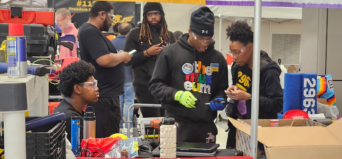 Students from the Anacostia High School Robotics team, the "AnaDroids," participated in a FIRST Robotics Competition in Severn, Maryland, supported by PAE SSP's Ishmael Kamara.