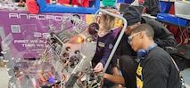 Students from the Anacostia High School Robotics team, the "AnaDroids," participated in a FIRST Robotics Competition in Severn, Maryland, supported by PAE SSP's Ishmael Kamara.