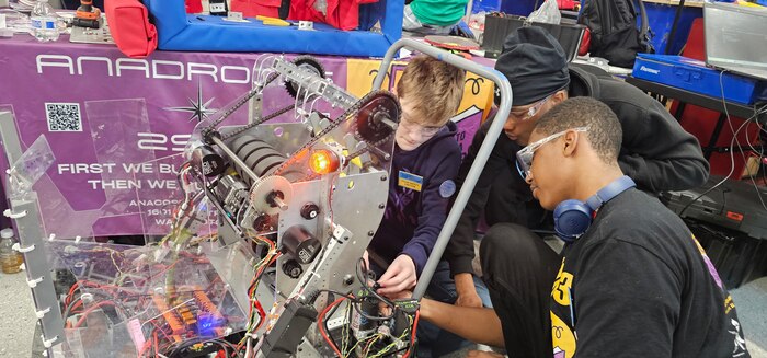 Students from the Anacostia High School Robotics team, the "AnaDroids," participated in a FIRST Robotics Competition in Severn, Maryland, supported by PAE SSP's Ishmael Kamara.