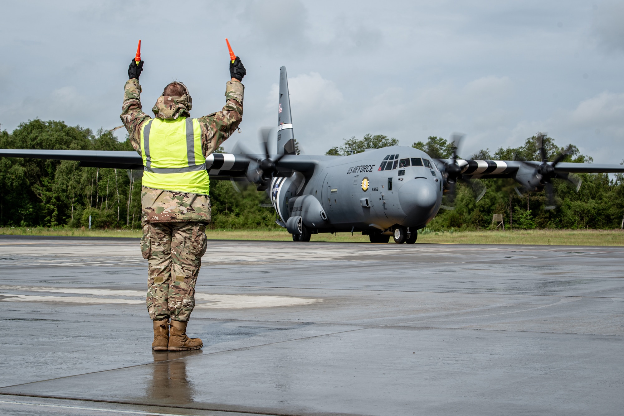 A crew chief assigned to the 123rd Airlift Wing, Kentucky Air National Guard, marshals a U.S. Air Force C-130J Super Hercules aircraft on the flight line at Karup Air Base, Denmark, June 8, 2026. The 123rd AW is providing tactical airlift support to NATO Allies throughout the month of June in support of Ramstein Flag 2026, an Allied Air Command large-scale, multi-location and joint operating area exercise with 18 participating nations and more than 200 aircraft. (U.S. Air National Guard photo by Master Sgt. Joshua Horton)