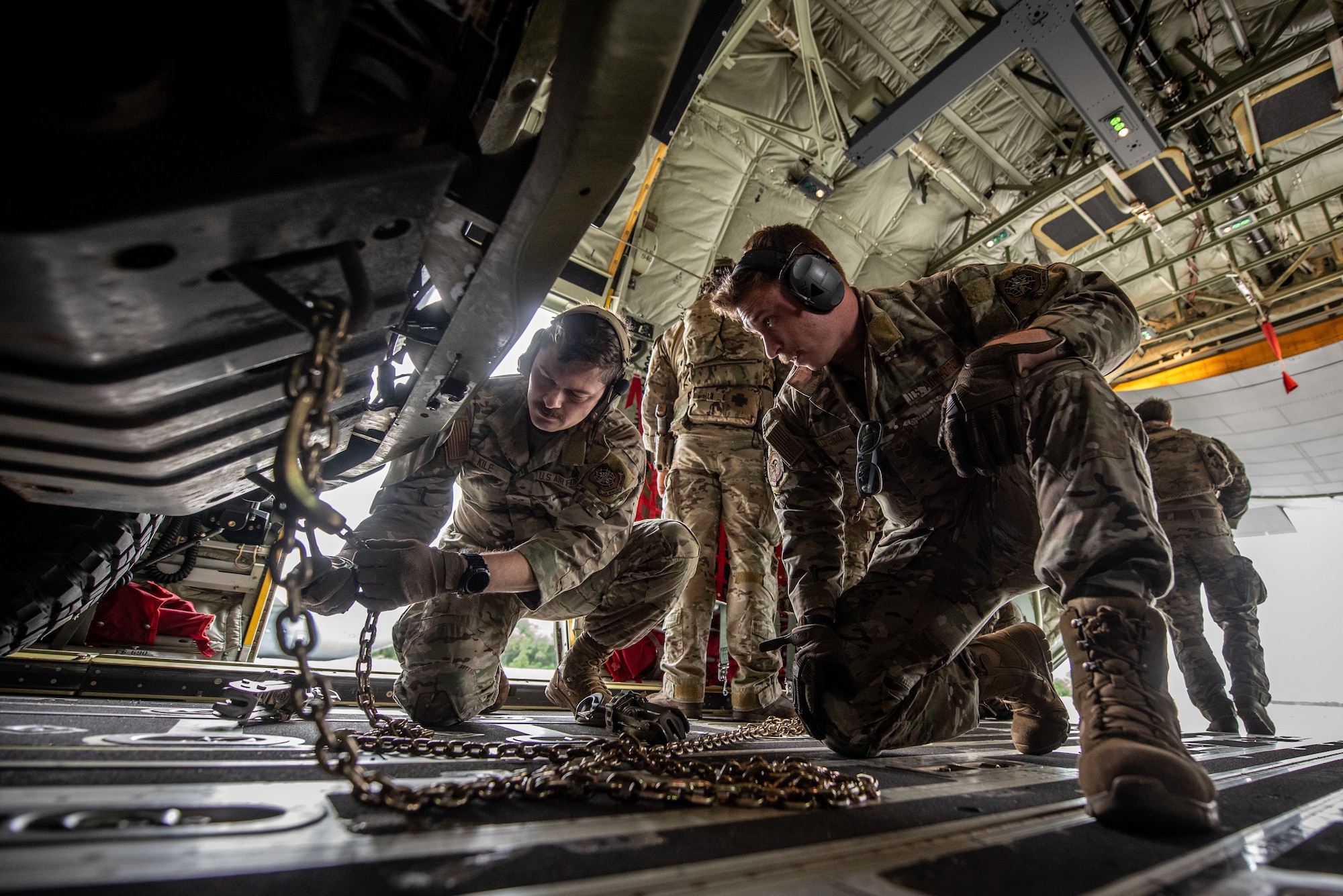 U.S. Air Force Airmen assigned to the 123rd Airlift Wing, Kentucky Air National Guard, secure cargo with tie-down chains on a C-130J Super Hercules aircraft at Karup Air Base, Denmark, June 9, 2026, during a search-and-recovery training scenario with the Danish Armed Forces. The 123rd AW is providing tactical airlift to NATO Allies throughout the month of June in support of Ramstein Flag 2026, an Allied Air Command large-scale, multi-location and joint operating area with 18 participating nations and more than 200 aircraft. (U.S. Air National Guard photo by Master Sgt. Joshua Horton)