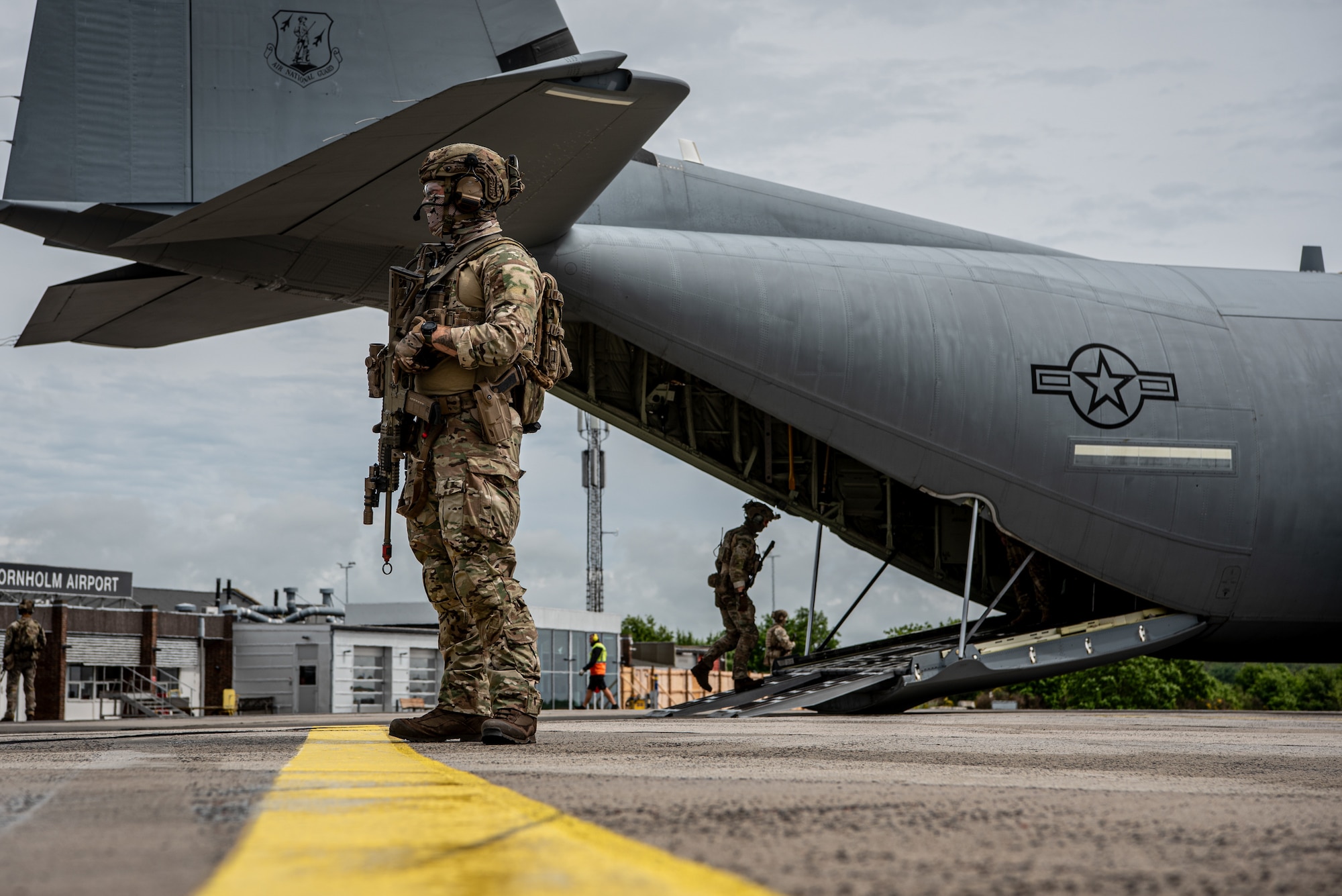 Members of the Danish Armed Forces provide perimeter security for a U.S. Air Force C-130J Super Hercules aircraft assigned to the 123rd Airlift Wing, Kentucky Air National Guard, during a search-and-recovery training scenario at Bornholm Airport near Rønne, Denmark, June 9, 2026. The 123rd AW is providing tactical airlift to NATO Allies throughout the month of June in support of Ramstein Flag 2026, an Allied Air Command large-scale, multi-location and joint operating area exercise  with 18 participating nations and more than 200 aircraft. (U.S. Air National Guard photo by Master Sgt. Joshua Horton)