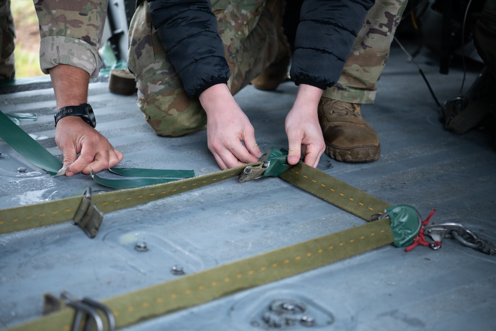 A soldier inspects contents of a backpack.
