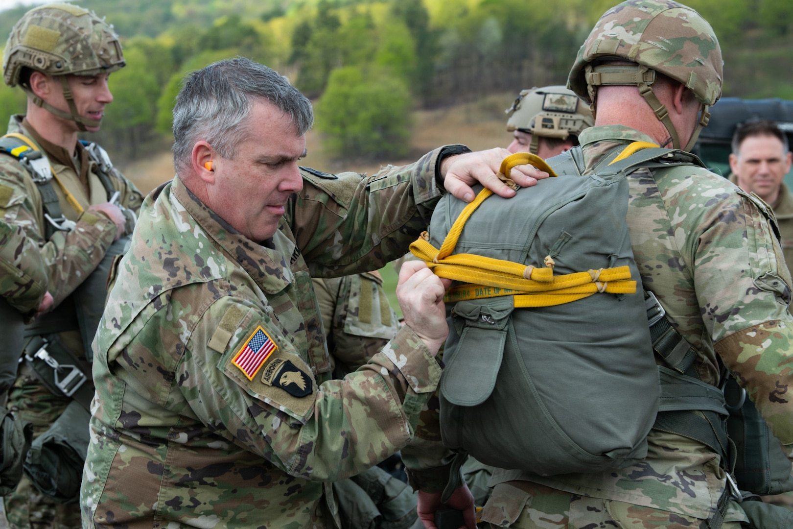 An Army soldier inspects a backpack on another soldier.