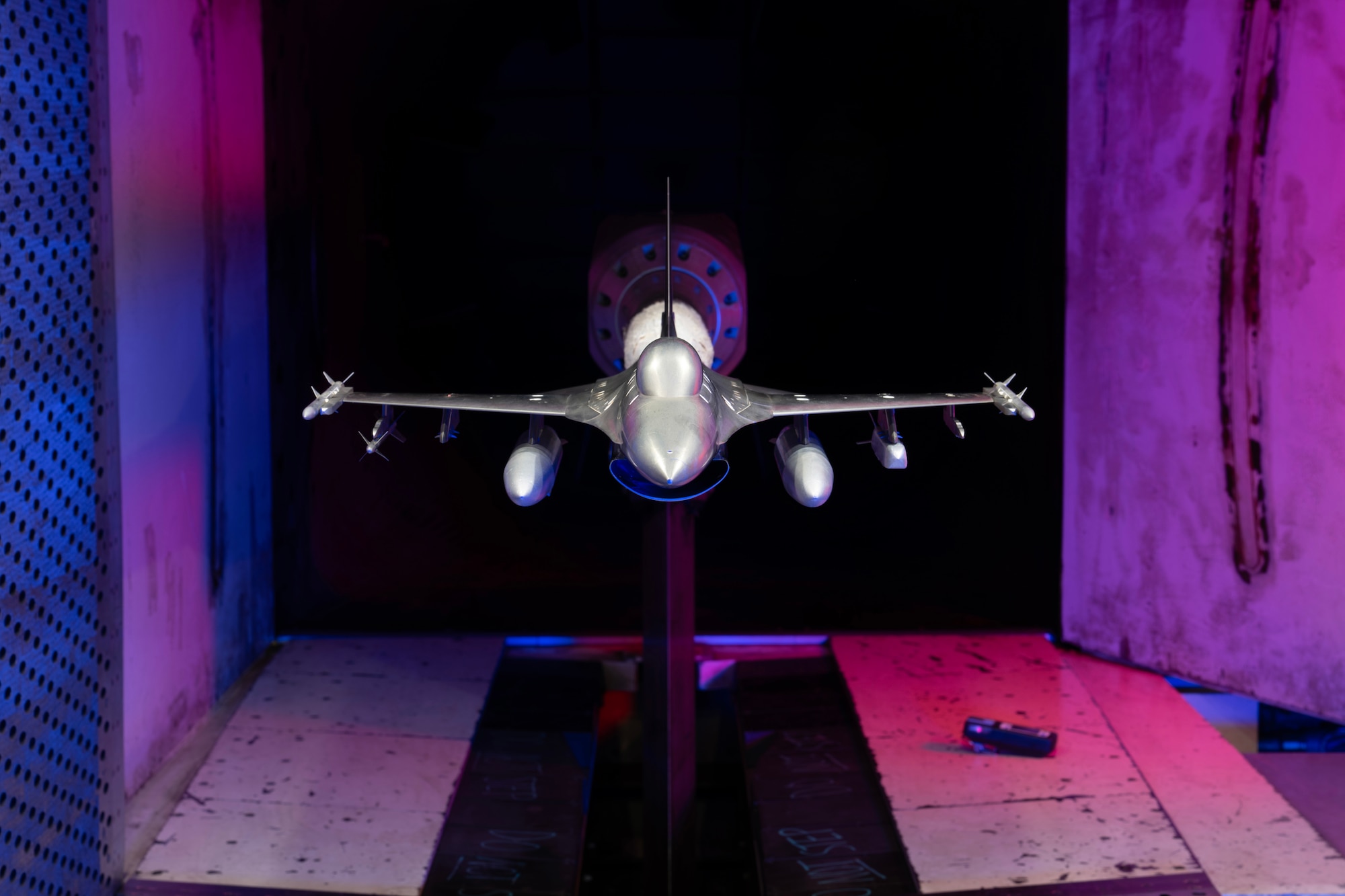 A model of the F-16 Fighting Falcon with weapon stores is pictured March 5, 2026, in the Aerodynamic Wind Tunnel 4T at Arnold Air Force Base, Tenn., headquarters of Arnold Engineering Development Complex. Members of the AEDC team at Arnold AFB recently rallied to meet an urgent test request. The AEDC Model Shop team fabricated a new weapon model in less than 24 hours, and engineers with the 716th Test Squadron tested the integration of the weapon stores with the F-16. Members of Team AEDC delivered test data only 67 hours after the test request was received. (U.S. Air Force photo by Keith Thornburgh)