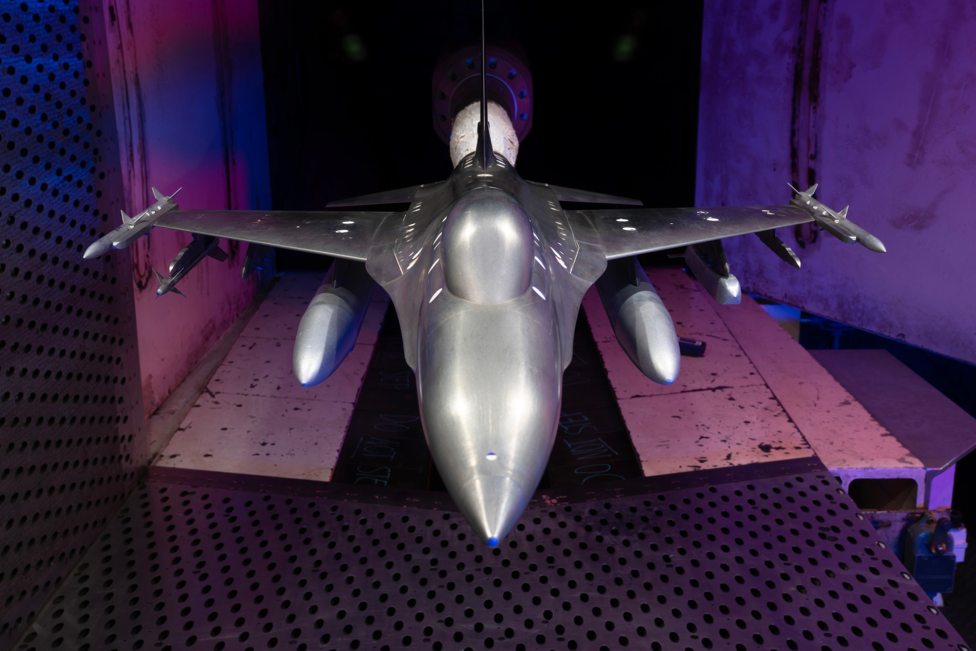 A model of the F-16 Fighting Falcon with weapon stores is pictured March 5, 2026, in the Aerodynamic Wind Tunnel 4T at Arnold Air Force Base, Tenn., headquarters of Arnold Engineering Development Complex. Members of the AEDC team at Arnold AFB recently rallied to meet an urgent test request. The AEDC Model Shop team fabricated a new weapon model in less than 24 hours, and engineers with the 716th Test Squadron tested the integration of the weapon stores with the F-16. Members of Team AEDC delivered test data only 67 hours after the test request was received. (U.S. Air Force photo by Keith Thornburgh)